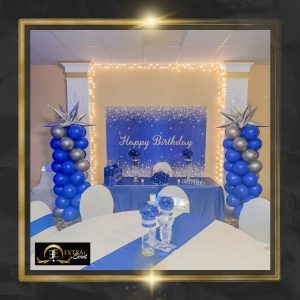a table with blue and silver balloons