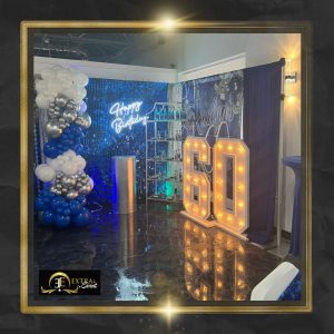 a room with balloons and a sign